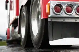 Close-up of a commercial truck’s rear wheels and mudflap
